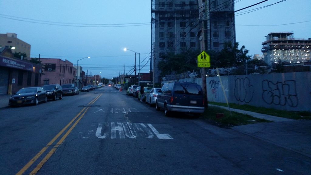Street-level low light example from Astoria Nyc, cropped to show the local street context.