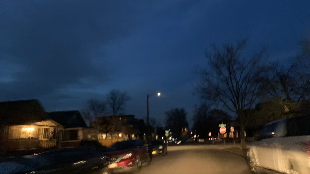Street-level low light example from Highlands Sloans Lake Denver, cropped to show the local street context.